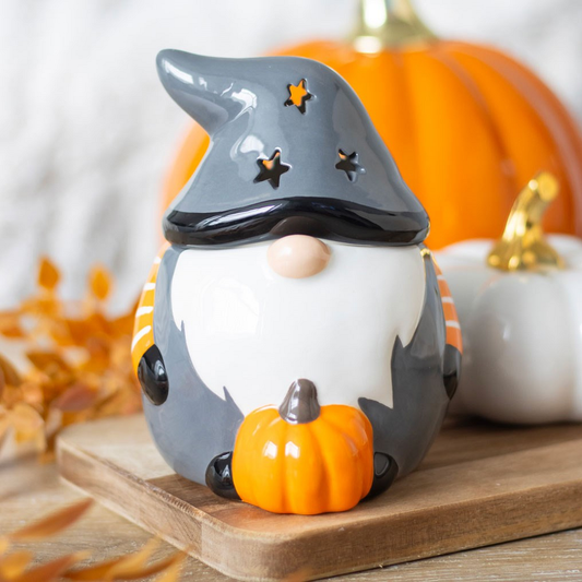 Add a touch of Halloween charm to your home with this Halloween Gonk Oil Burner. This festive gonk, wearing a grey top with orange and white stripe sleeves, features a star cut out design on the hat giving a magical glow, making it the perfect seasonal décor. Bring the magic of Halloween into your space with this cute oil burner