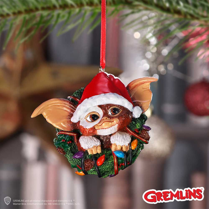 Gremlins Gizmo in Wreath  Hanging Ornament. Gizmos head, ears and hands wearing a christmas hat poking through the middle of a green christmas wreath - Nemesis Now ornament 