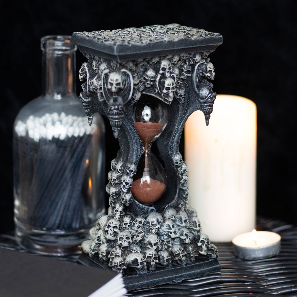 Sands Of Death Hourglass Timer. Behold the captivating décor of the Sands Of Death Hourglass Timer! This resin and glass timer combines art and functionality, filled with red sand