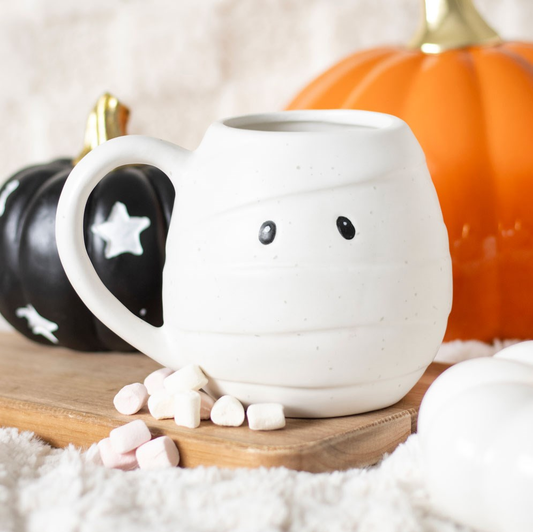 Unwrap the perfect addition to your Halloween homeware with this Mummy Shaped Rounded Mug. With its white speckled design and bandage detail, this rounded mug will keep your favourite drinks under wraps. Plus, those little black eyes add a touch of spooky fun to your kitchenware