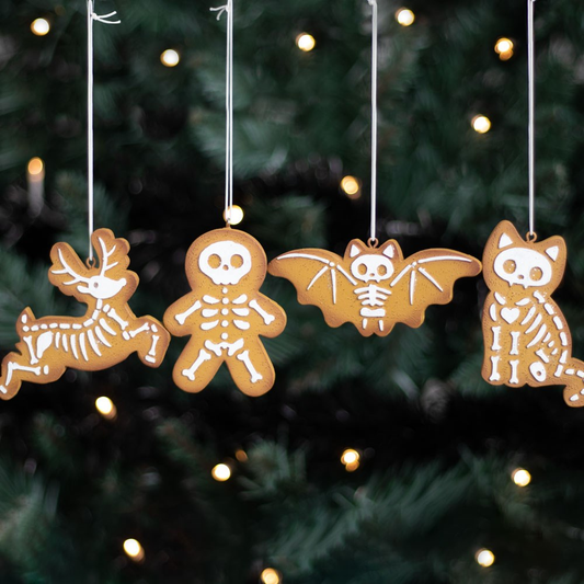 Set of four Creepy Skeleton Cookie Ornaments. A spooky take on the traditional gingerbread cookie ornaments featuring a gingerbread man, skeleton reindeer, bony bat and creepy cat