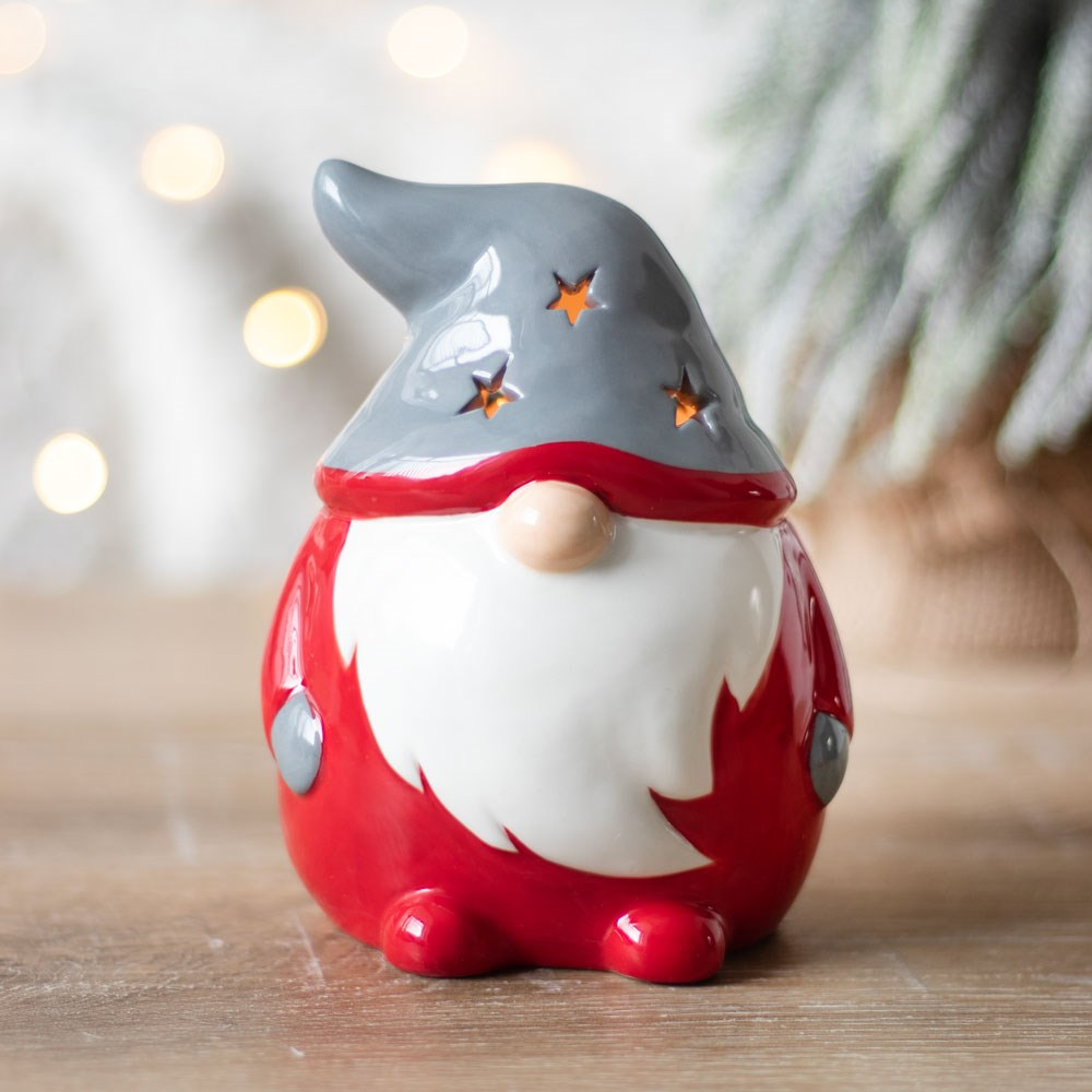 Red & Grey Gonk Tealight Holder. A wonderful Christmas Gonk / Gnome to help bring festive glow to your home, place a standard tealight inside and see the soft glow through the star shapes in the hat and back.