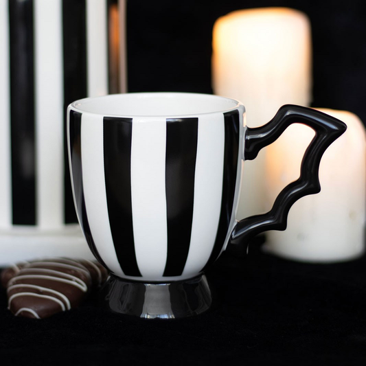 Striped Bat Wing teacup - add some eerie charm to any spooky and sophisticated tea party. The monochrome stripes and elegant bat wing handle make this gothic homeware a must-have for any lover of the strange and stylish