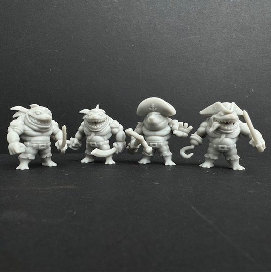 Shark Chibis A by Iron Gate Scenery.&nbsp; A set of four 28mm scale printed resin miniatures representing pirate weresharks in a chibi style, holding various weapons in various characterful poses for your tabletop games,&nbsp;Dungeons and Dragons (D&amp;D) or RPG game