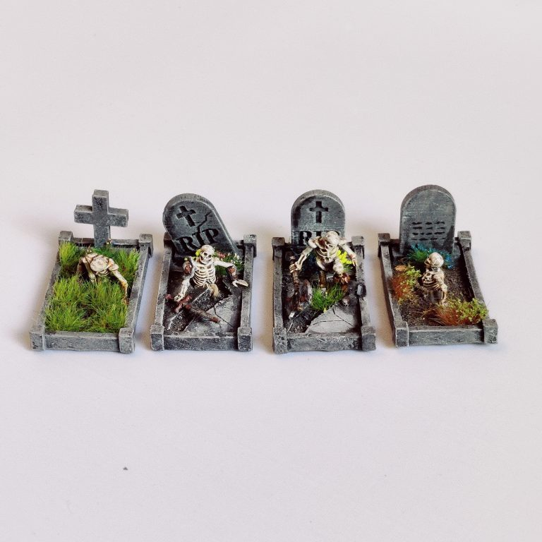 A pack of four Skeleton Grave Surrounds by Iron Gate Surrounds printed in resin to a 28mm scale. Fantastic grave surrounds (headstones not included) with skeletons coming out of the ground making a wonderful edition to your&nbsp;Halloween dioramas, RPGs, dungeon settings, tabletop games and more