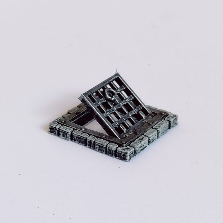 A pack of two grated trapdoors by Iron Gate Scenery in 28mm scale made from PLA . These trapdoors represent bricked traps with grated door that actually opens to help you decorate your dungeon setting, RPGs, tabletop gaming and more.&nbsp;