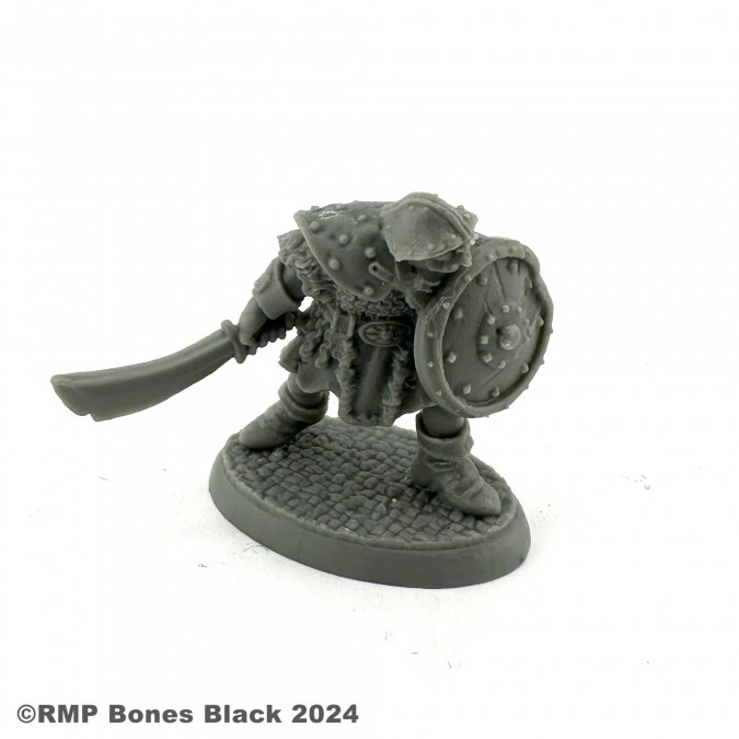 20319 Orc Warrior with sword down by Reaper Miniatures from their Bones Black range sculpted by Bobby Jackson for your tabletop gaming needs. A great gaming figure of an Orc holding&nbsp; a shield in front and a sword by the side