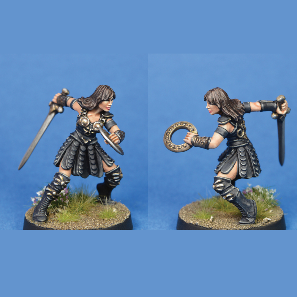 Divine Mortal by Crooked Dice, one 28mm scale white metal miniature for your RPG or tabletop game representing a female warrior wearing leather style armour and holding a&nbsp; sword in one hand and a donut style disc in the other sculpted in a dynamic pose.&nbsp;