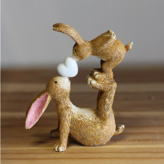 Wonderful bunny ornament of a rabbit and baby bunny adorably posed with the baby bunny standing on the rabbits feet and nose kissing a heart. A sweet figurine  that would make a beautiful gift or edition to your own home. 