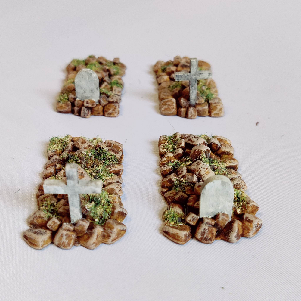 Boothill Cemetery Graves by Iron Gate Scenery printed in resin for 28mm scale. With two graves with crosses and two graves with rounded headstones helping you to add detail to your town scenery, RPGs, tabletop games, church scenery and more