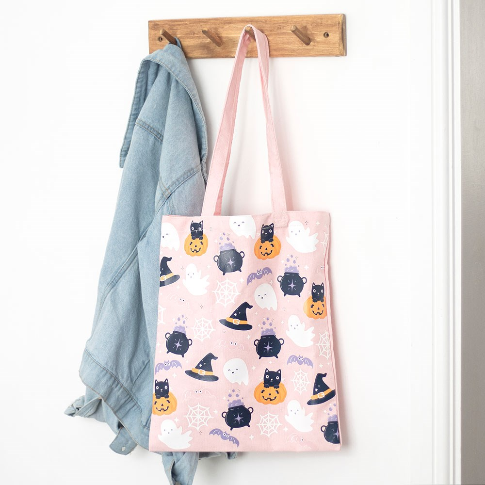 &nbsp;Cute Halloween Print Tote Bag featuring cute ghosts, bats, pumpkins and cats print against a pink background. This polycotton canvas tote bag is perfect for carrying all your essentials and adding some fun, spooky, pastel gothic vibes to your wardrobe