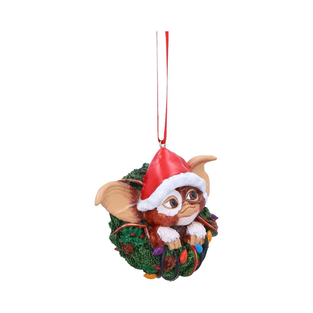 Gremlins Gizmo in Wreath  Hanging Ornament. Gizmos head, ears and hands wearing a christmas hat poking through the middle of a green christmas wreath - Nemesis Now ornament 