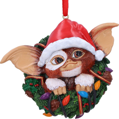 Gremlins Gizmo in Wreath  Hanging Ornament. Gizmos head, ears and hands wearing a christmas hat poking through the middle of a green christmas wreath - Nemesis Now ornament 