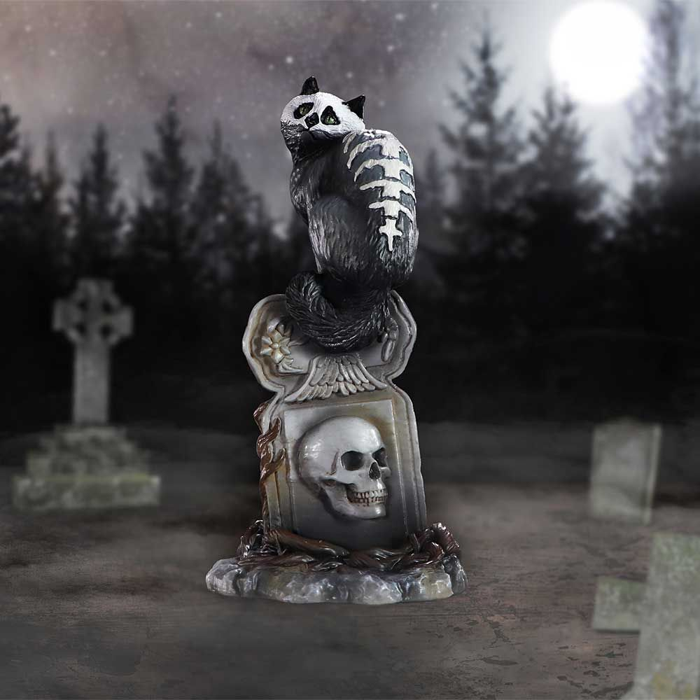 Gothic skull cat by Martin Handford from Nemesis Now. Perched on top of an ornate gravestone this black feline with green eyes and exposed skull and spine with add an unusual edition to your cat figurine collection for Halloween and all year round.