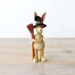 Rabbit With Broom Standing. A wonderfully characterful bunny standing straight and wearing black witches hat while holding a broomstick to its side, making a great edition to your spooky decoration, Halloween tier tray or a gift for a friend.