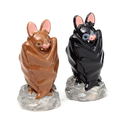 Bat Salt & Pepper shaker set to add a spooky yet adorable edition to your tableware. With one bat in black, one in brown and both with their wings wrapped around their bodies sat on rocks to add a stable element to the condiment set