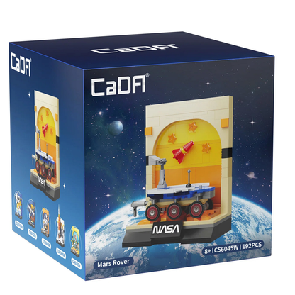 A cube shaped box in dark blue with image of space and dome of the earth with a lego style Mars Rover display on the front.  This Cada bricks Mars Rover Lego compatible building bricks kit enables you to build your own NASA licensed display capturing the essence of this iconic vehicle which can be detached and used for play