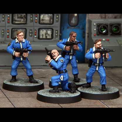 Minion with SMGs by Crooked Dice, a set of four 28mm scale metal miniatures depicting henchmen wearing matching blue uniforms and black boots, with all four holding classic SMGs and one down on one knee pointing his gun upward. 