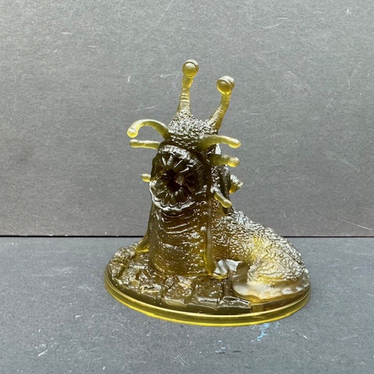 Giant Slug from Reaper Miniatures. An unboxed / not in retail packaging giant slug in translucent plastic and integral bases from the Bones6 kickstarter for your roleplaying games (RPG), painting, collecting and gaming needs