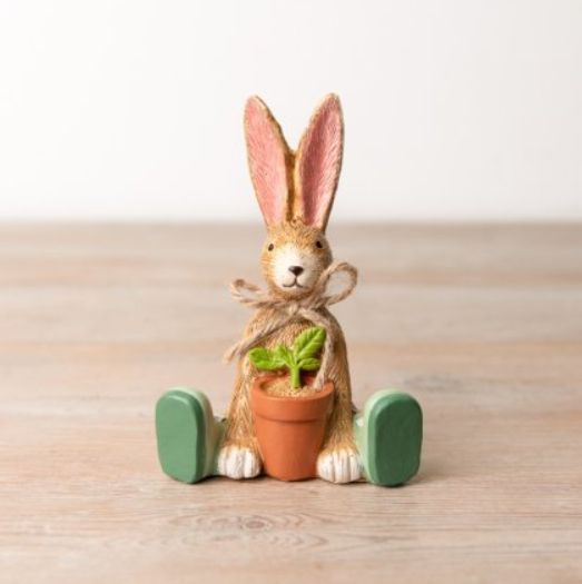 Sitting Rabbit With House Plant.&nbsp;&nbsp;A characterful sitting bunny ornament wearing green boots, rustic jute bow and with a potted plant in between its paws making a great gift for a green fingered friend or your own home