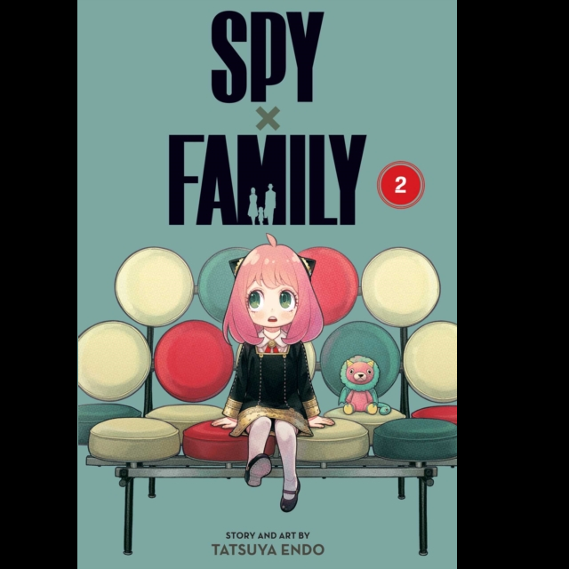 Spy x Family Vol. 2 a 200 page paperback fantasy manga graphic novel. a dusky green background with a small child with pink hair sat on a colourful chair made of circles