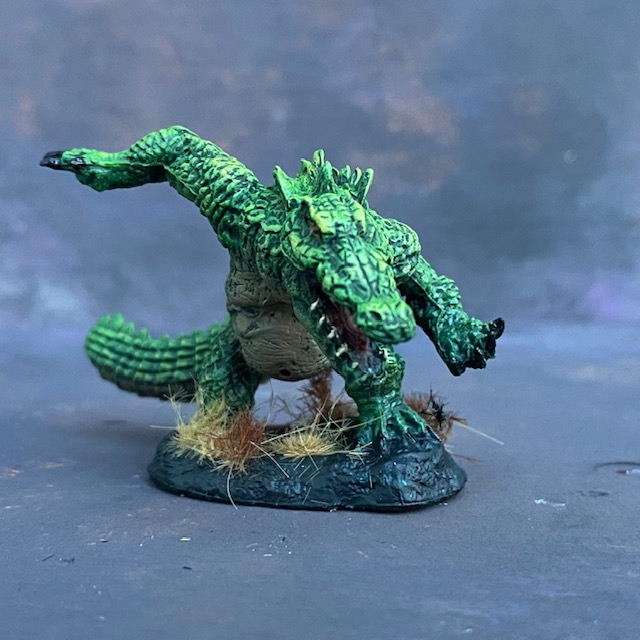 Werecrocodile by Reaper Miniatures from their Bones range pre painted by Mrs MLG.  A bones miniature of giant crocodile painted in greens.