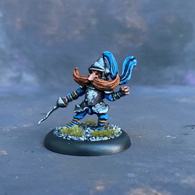 The Knight by Northumbrian Tin Solider from their Nightfolk range pre painted by Mrs MLG.  A metal miniature knight with a blue adornment to his helm and a rather excellent moustache. 