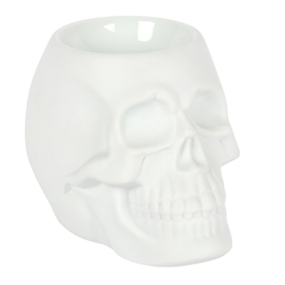 A matt white skull oil burner