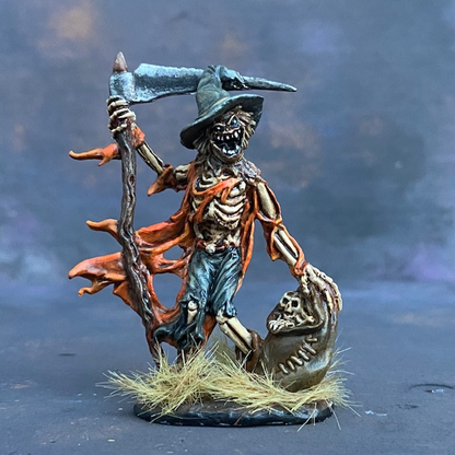 Gauntfield by Reaper Miniatures from their Bones range pre painted by Mrs MLG.  A bones miniature of a skeleton scarecrow holding a scythe in one hand and a bag of bones in the other, pre painted with orange and blue colours.