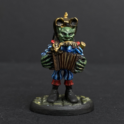 Hand painted one man band from the Reaper Miniatures range. Mrs MLG has painted this wonderful little goblin playing all his instruments for the one man band using a blue and red colour scheme for his clothing. 