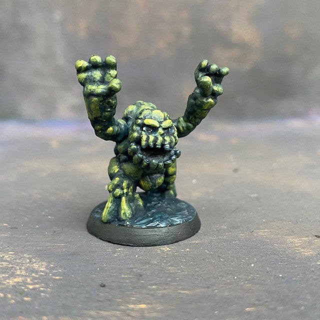 Boulderkin from the Reaper Miniatures range pre painted by Mrs MLG. This cute but angry little rock monster is painted with a limited pallet of yellow, green and black