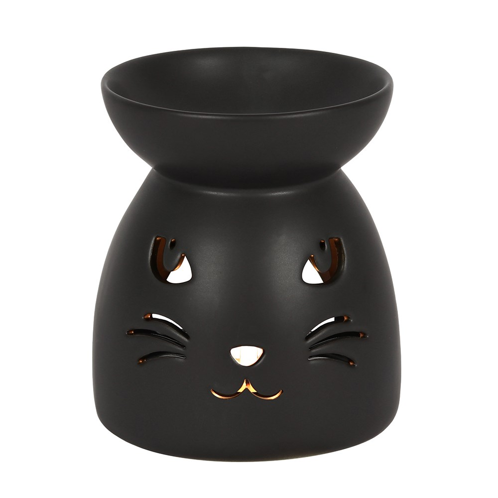 A matt black oil burner with a cut out cat face design