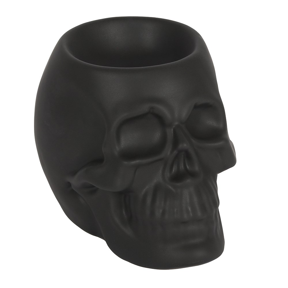 A matt black skull oil burner