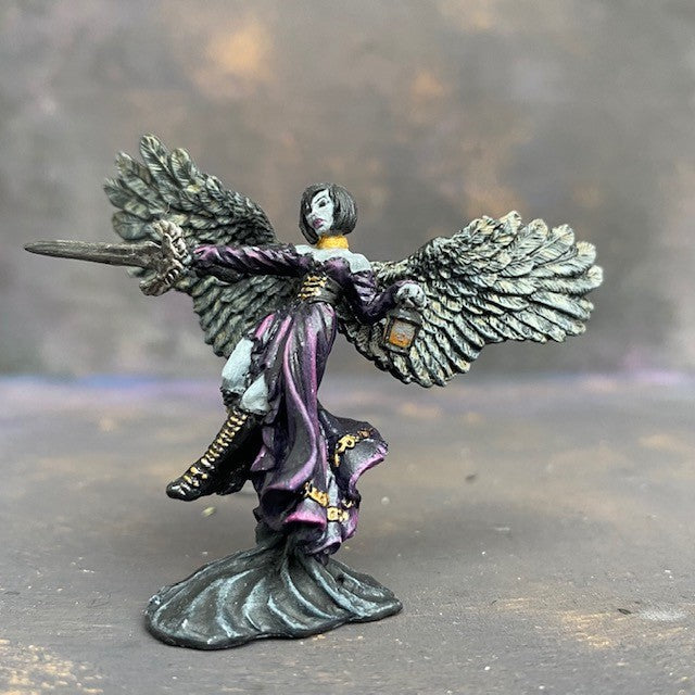 Angel of Shadows from the reaper miniatures bones range pre painted by Mrs MLG. This angelic miniature is painted with purples, blues, grey and golds, she holds a sword in one hand and a lantern in the other.