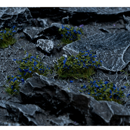 Tufts covered with dark blue petals and green leaves by Gamers Grass