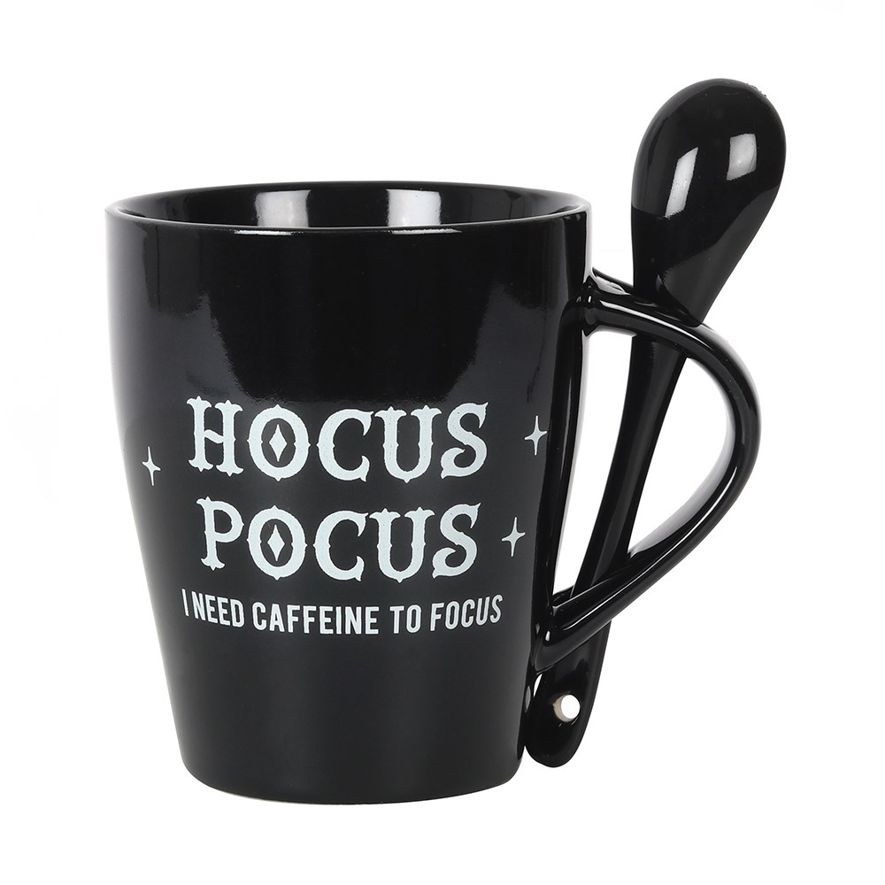 A lovely mug and spoon set in black, the mug has white writing saying Hocus Pocus I need caffeine to focus and the spoon has a crescent moon and stars motif.