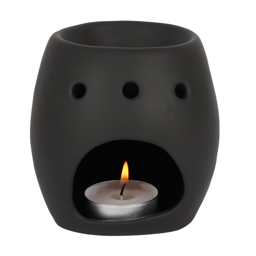 A matt black skull oil burner