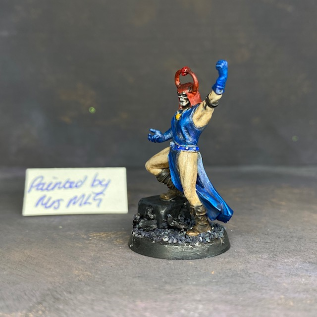 A sorcerer painted by Mrs MLG. This resin printed miniature is in the style of the hero quest sorcerer, painted with blue clothing and red headdress.  