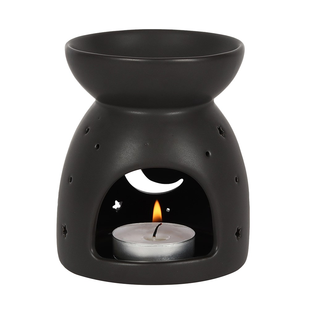 A matt black oil burner with a cut out crescent moon and star design