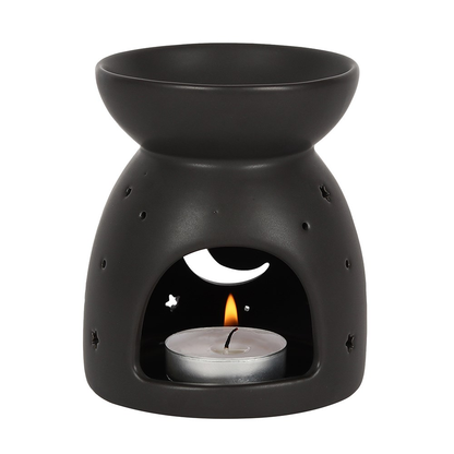 A matt black oil burner with a cut out crescent moon and star design