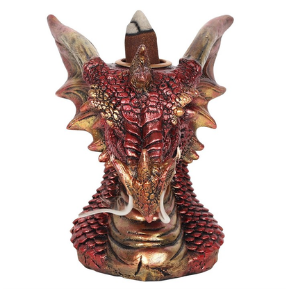 A red and gold dragon head with green eyes incense burner 