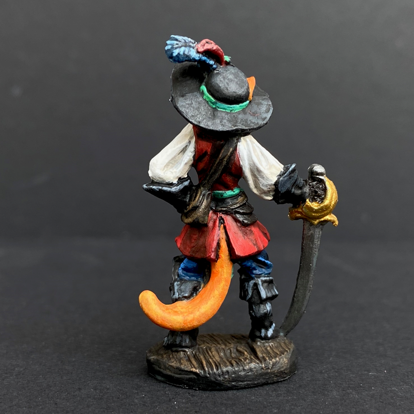 Hand painted debonair cat from the Reaper Miniatures range. Mrs MLG has painted this catfolk cavalier as a ginger cat with a blue, green and red colour scheme clothing having black hat, boots and gloves. 