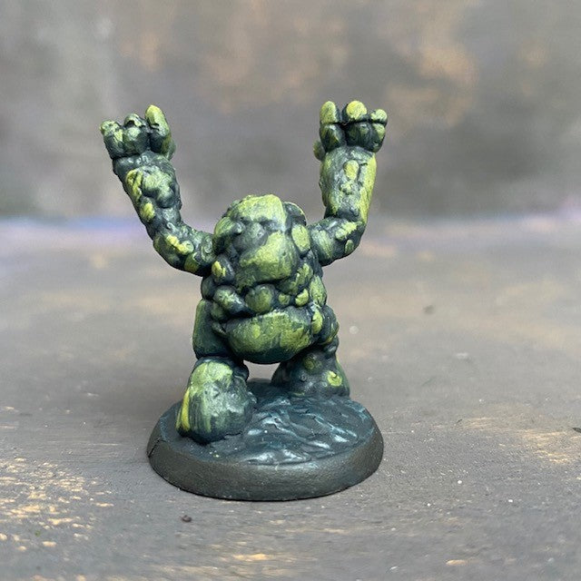 Boulderkin from the Reaper Miniatures range pre painted by Mrs MLG. This cute but angry little rock monster is painted with a limited pallet of yellow, green and black