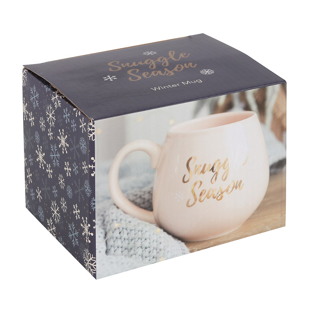 A beautiful soft pink coloured rounded mug with gold writing saying 'Snuggle Season'.