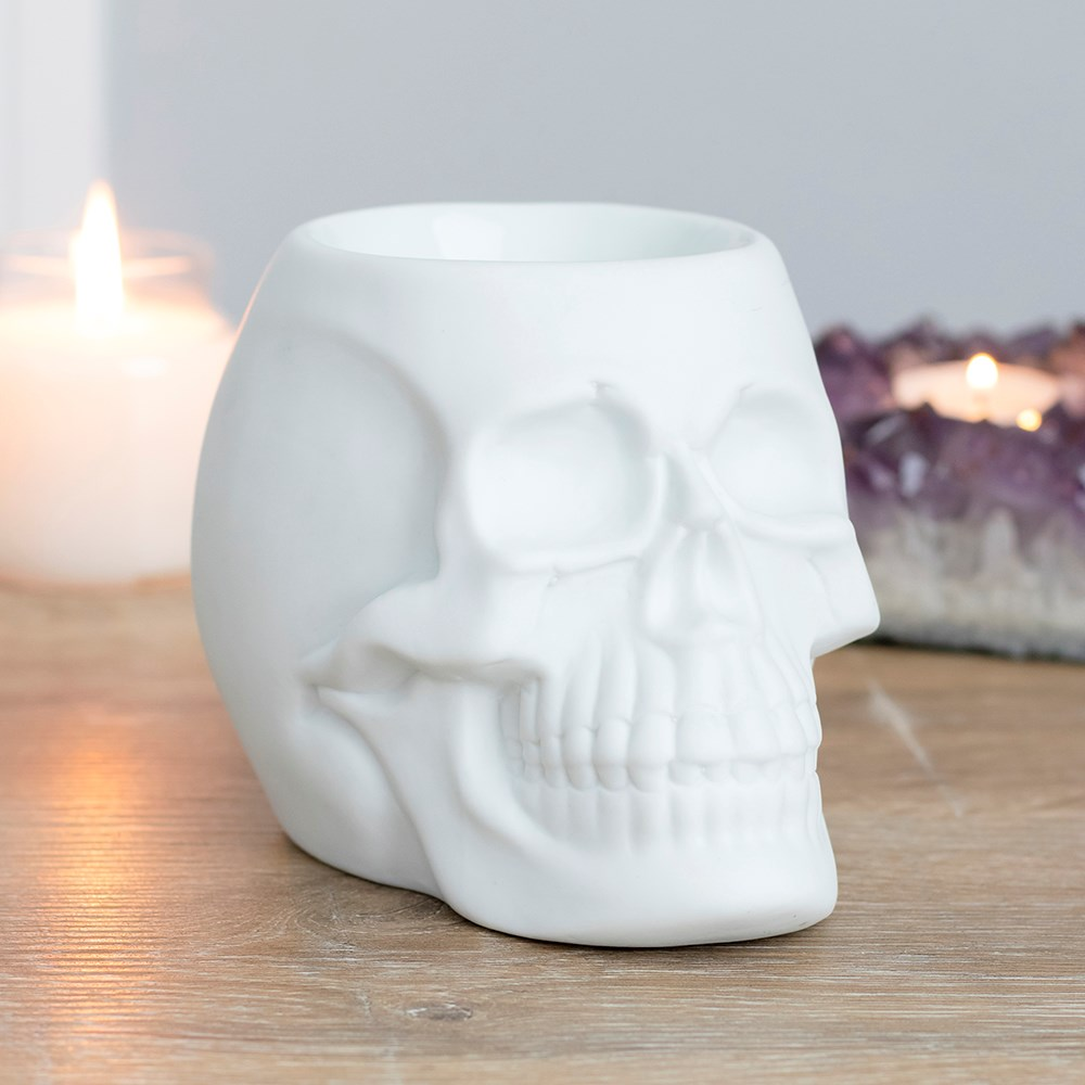 A matt white skull oil burner