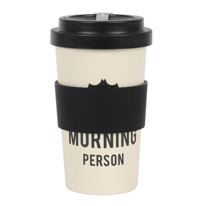 travel mug in a cream colour with an upside down bat and the words 'Not a morning person' written in black, topped with a black lid.