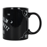 side view of black mug with white moon and pentagram design 
