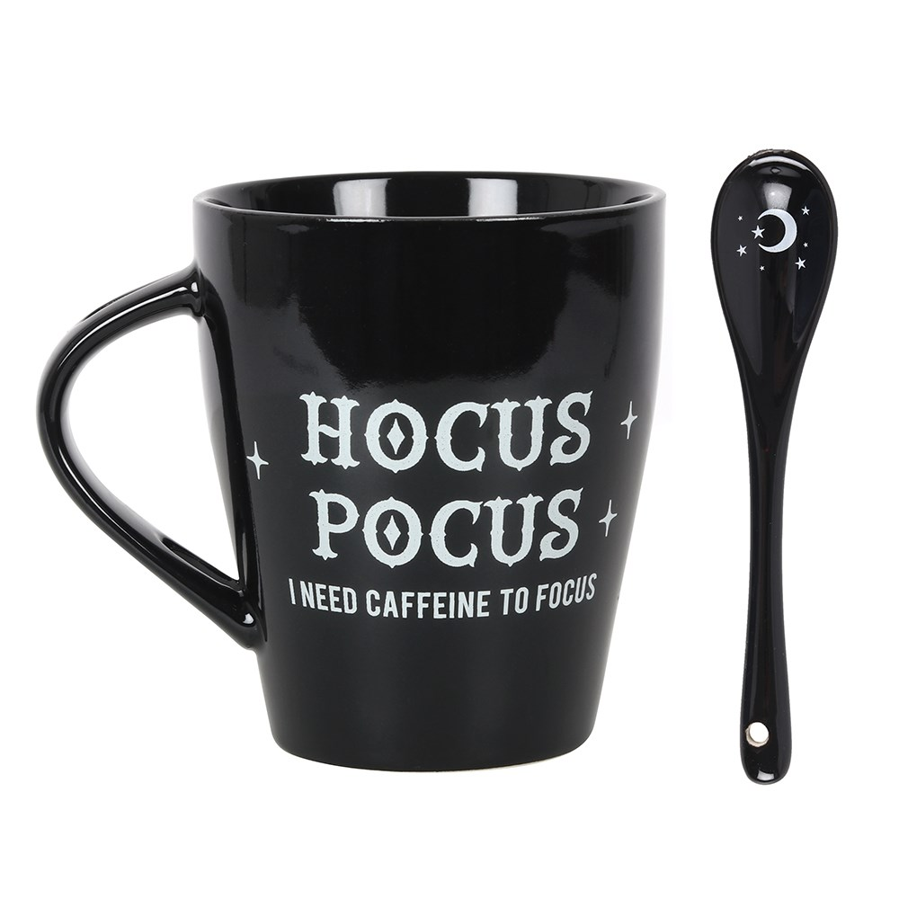 A lovely mug and spoon set in black, the mug has white writing saying Hocus Pocus I need caffeine to focus and the spoon has a crescent moon and stars motif.