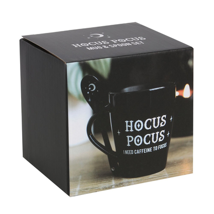 A lovely mug and spoon set in black, the mug has white writing saying Hocus Pocus I need caffeine to focus and the spoon has a crescent moon and stars motif.