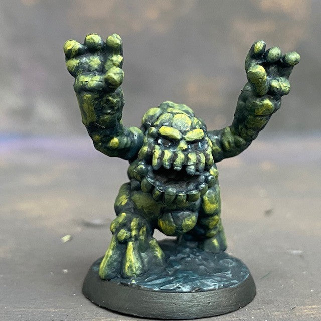 Boulderkin from the Reaper Miniatures range pre painted by Mrs MLG. This cute but angry little rock monster is painted with a limited pallet of yellow, green and black